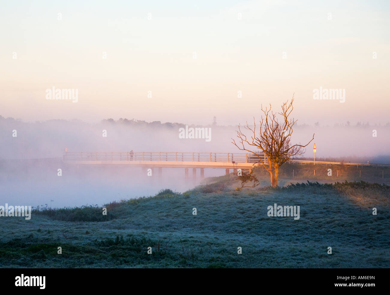 Early morning mist / fog over the river Avon Causeway, Christchurch, Dorset. UK. Ground frost on the grassy banks of the river. Stock Photo