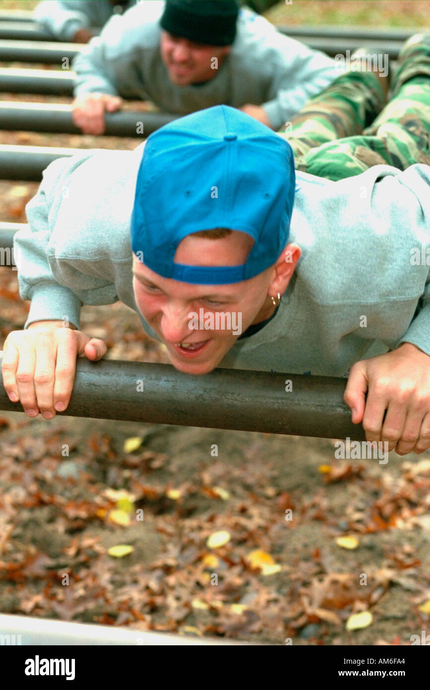 Boy age 14 crossing obstacle course on youth center retreat. Camp Ripley Minnesota USA Stock Photo
