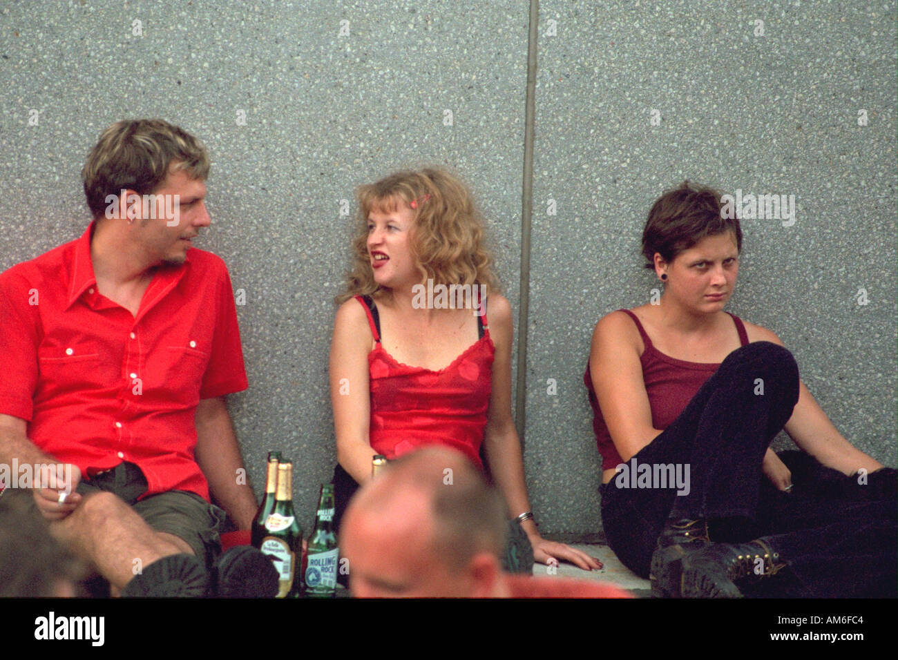 Friends age 24 smoking drinking and talking at Bastille Day Festival. Minneapolis Minnesota USA Stock Photo