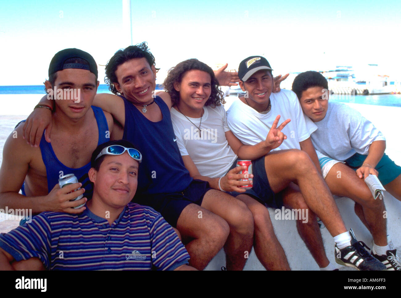 Mexican friends age 18 hanging out on waterfront.  Cozumel Mexico Stock Photo
