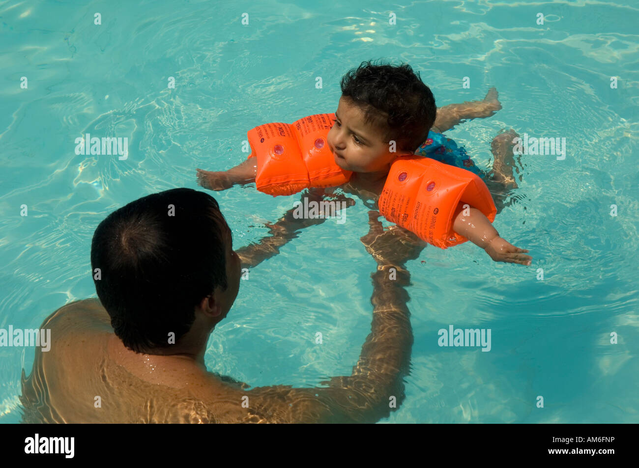 6 months old baby swimming in pool with his father Stock Photo - Alamy