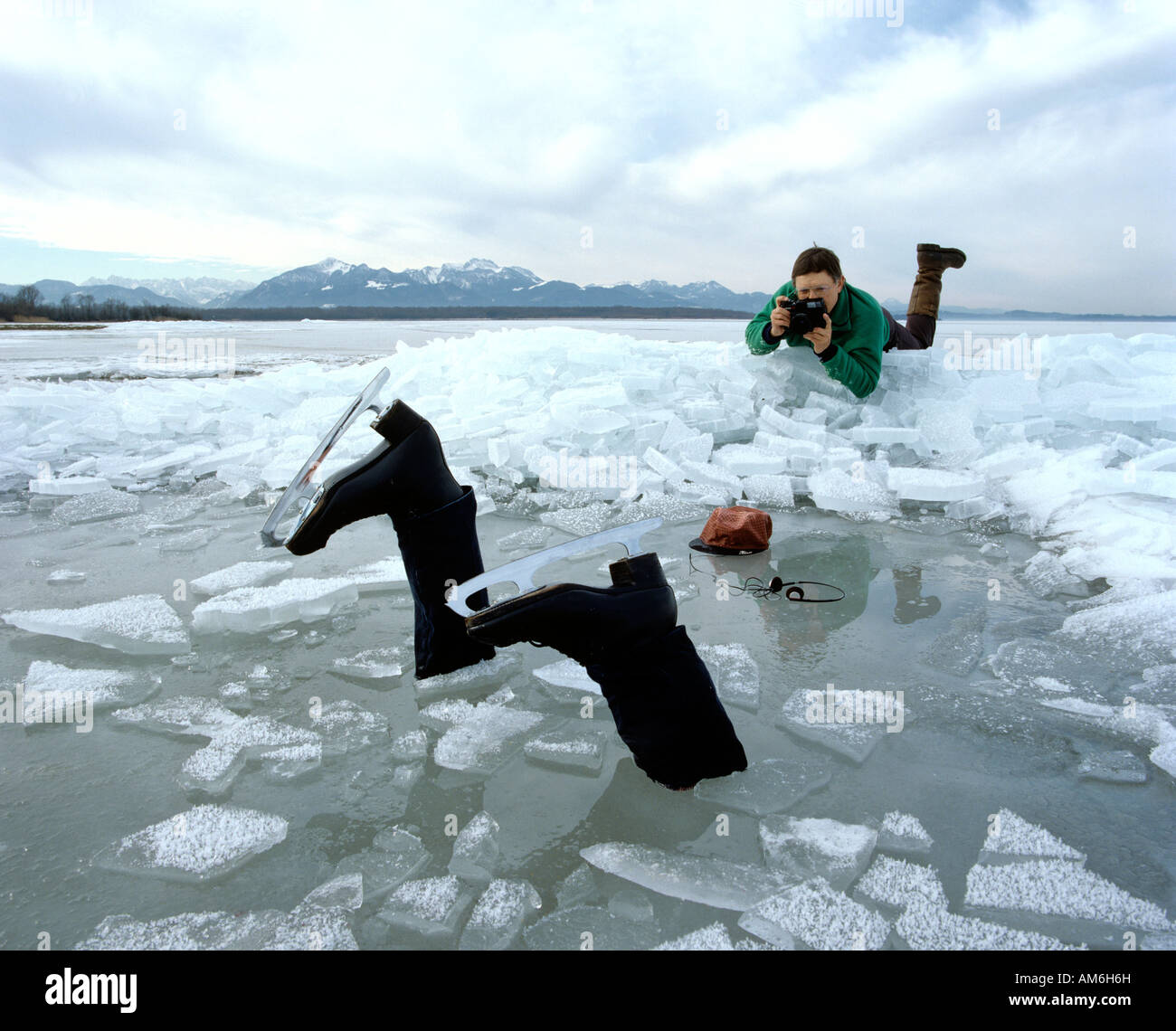 Broken in ice-skater and photographer, Chiemgau Upper Bavaria Germany Stock Photo