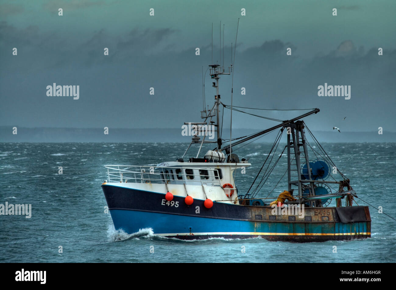 Fishing boat in choppy seas Stock Photo - Alamy