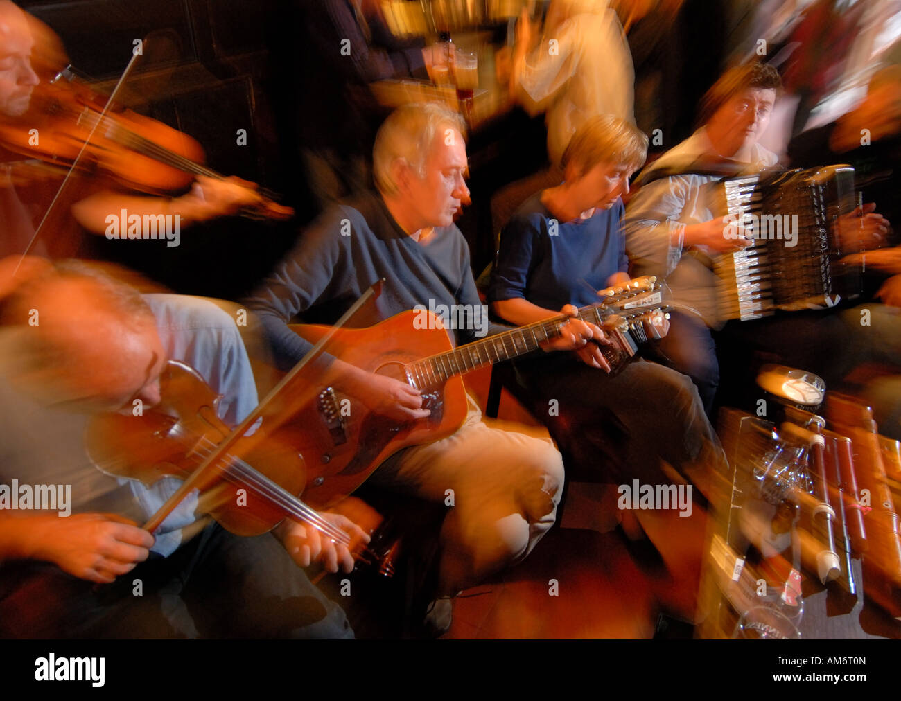 A group of folk musicians performing during an open session at the Sandy's Bell pub in Edinburgh Scotland Stock Photo