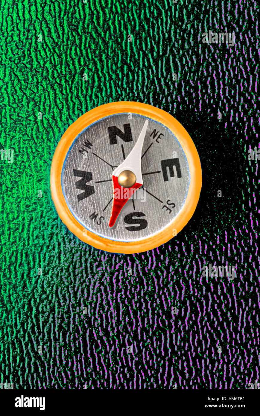Close up of compass digitally enhanced on green background Stock Photo