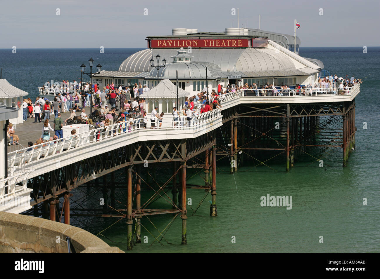 Cromer Pier and Pavillion Theatre stand in an emerald green North Sea, Cromer Norfolk East Anglia England UK GB Stock Photo