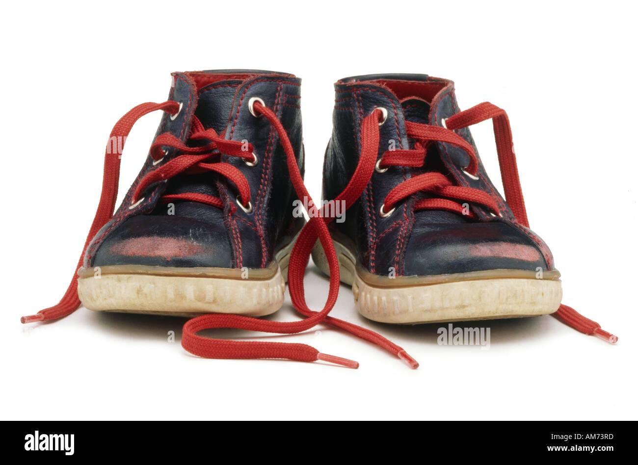 A blue pair of children s shoes with red laces Stock Photo