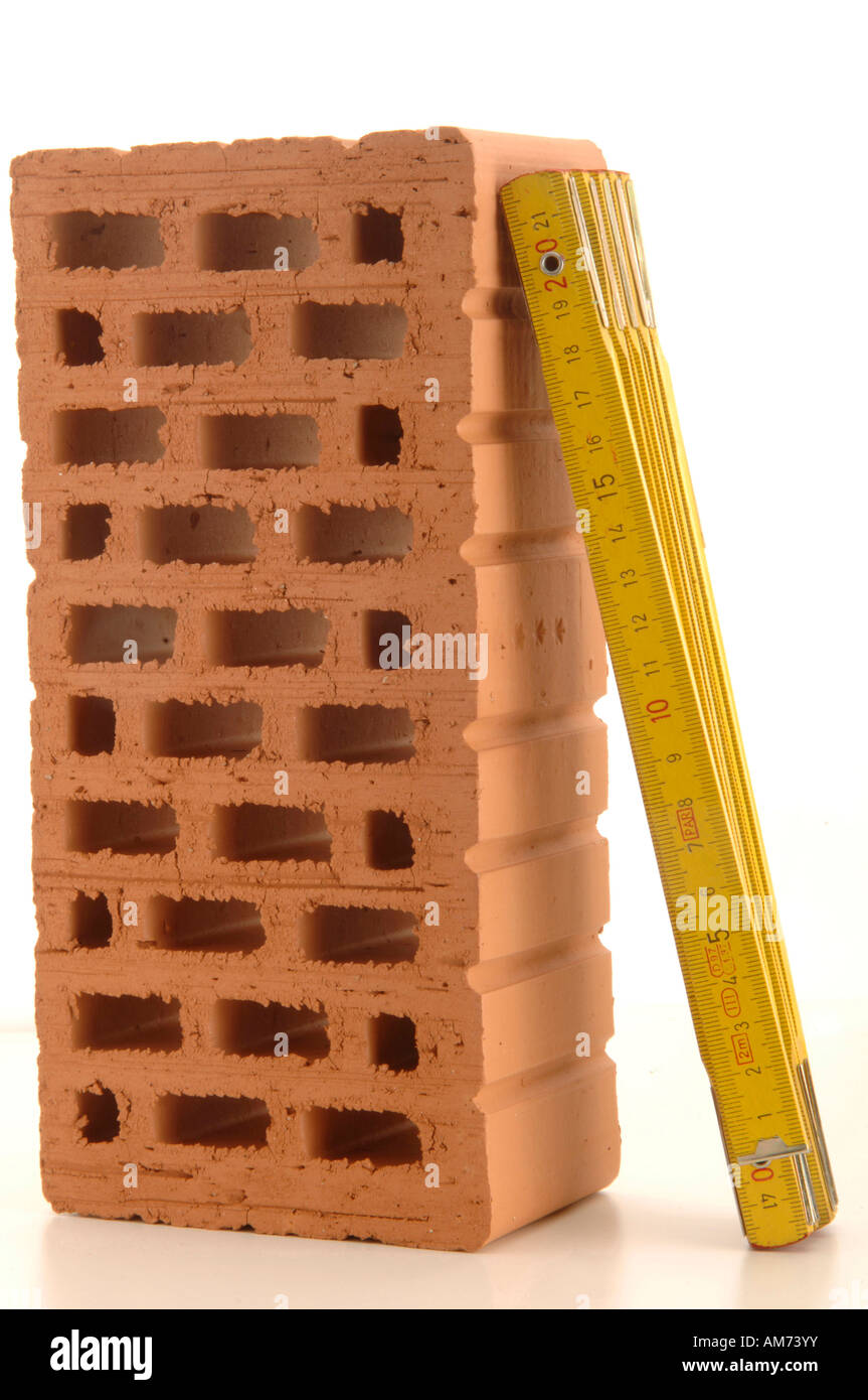 Ruler leaning against brick Stock Photo