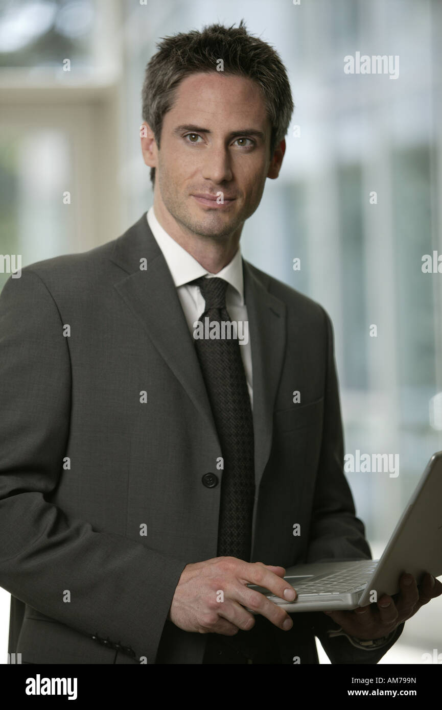 Business man with laptop in the lobby Stock Photo