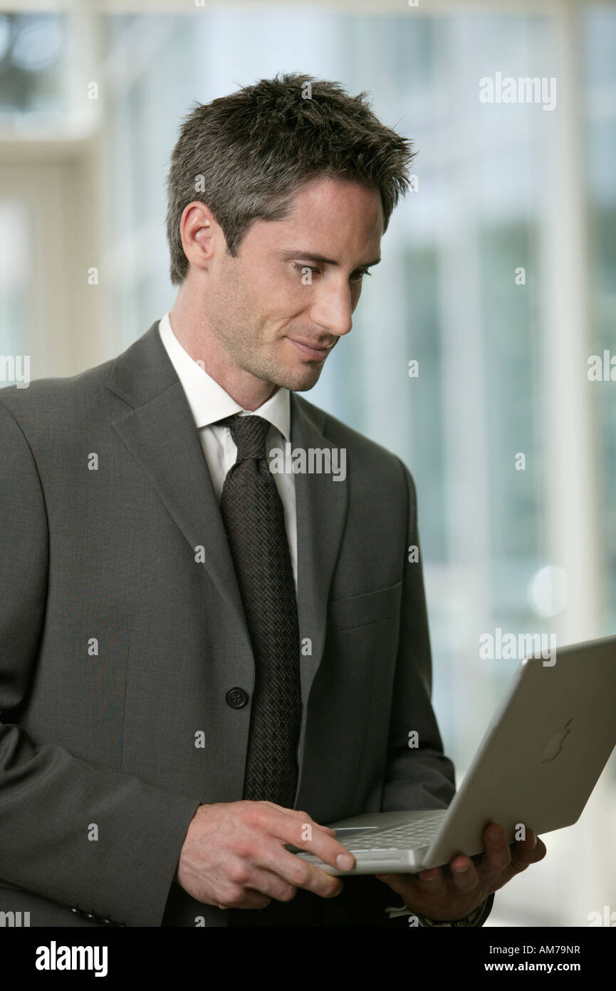 Man in suit with laptop Stock Photo