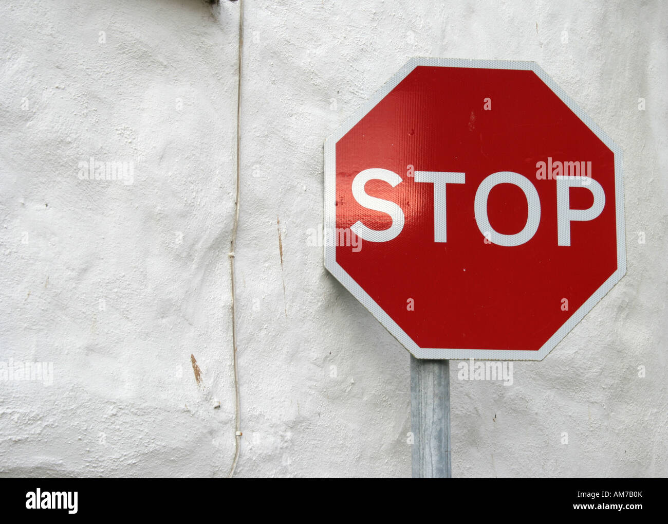 Stop sign in front of white wall, Marazion, Cornwall, Great Britain ...