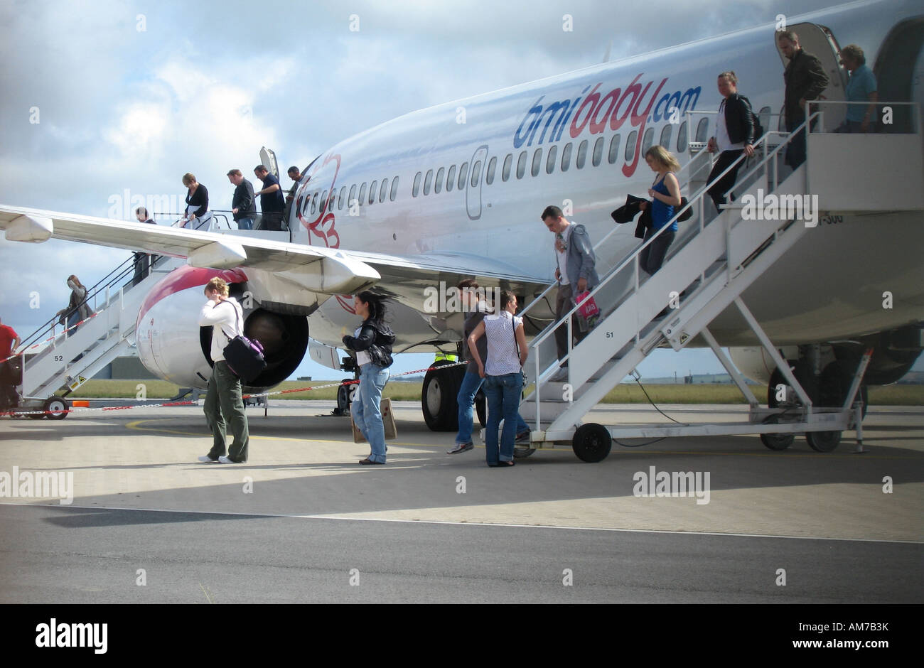 Passengers leaving a Boeing 737 of bmibaby at Newquay Airport, Cornwall, Great Britain Stock Photo