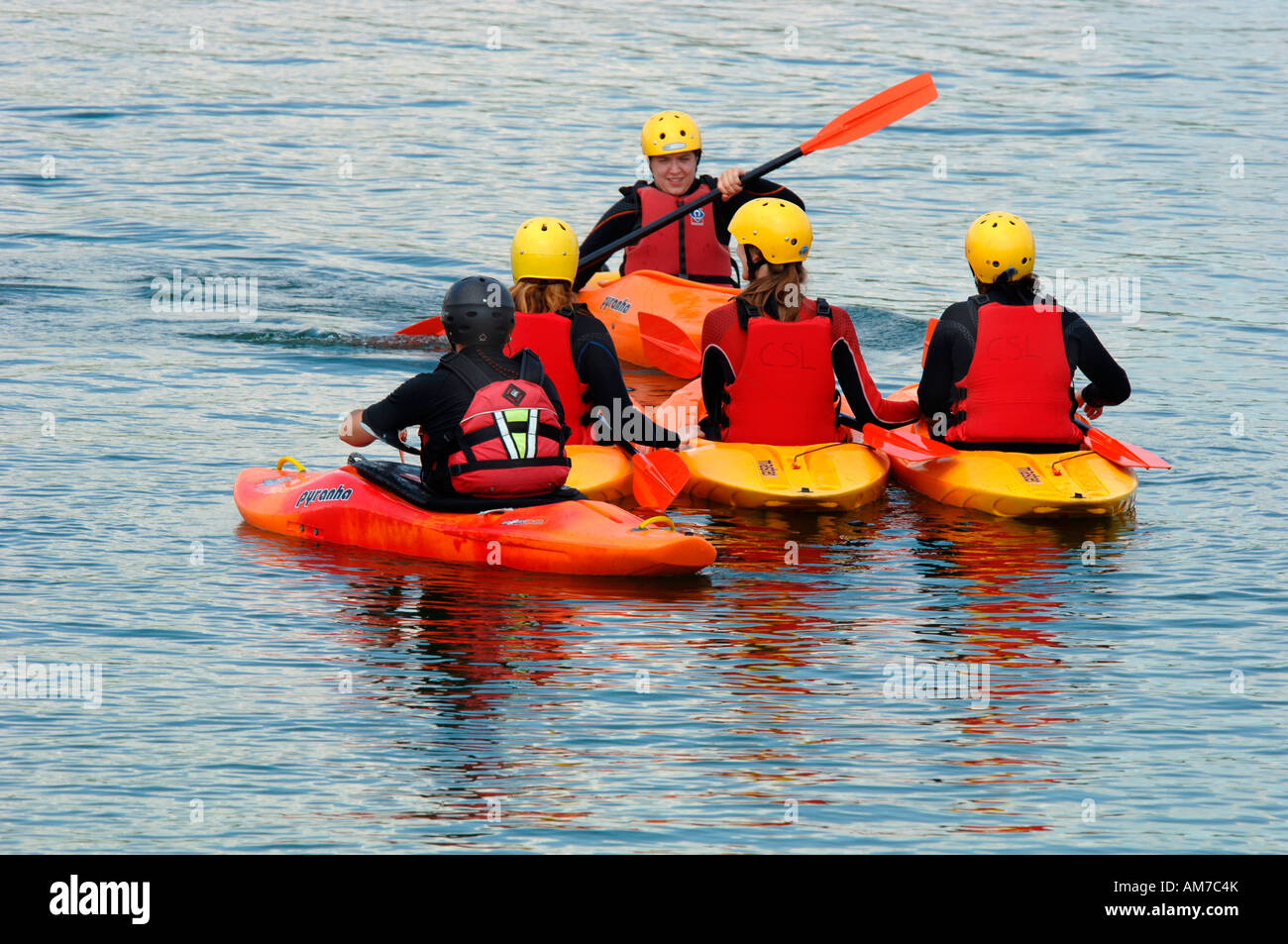 A Group Of Young People Learning Canoeing Skills From A Tutor,On