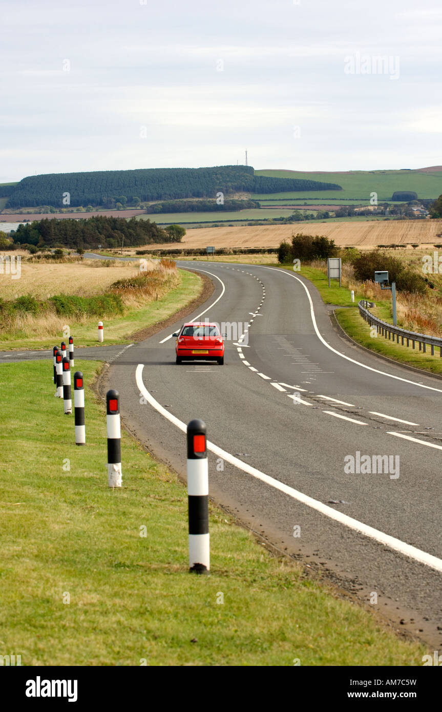 Red car travelling south along the A1 road, Scotland Stock Photo