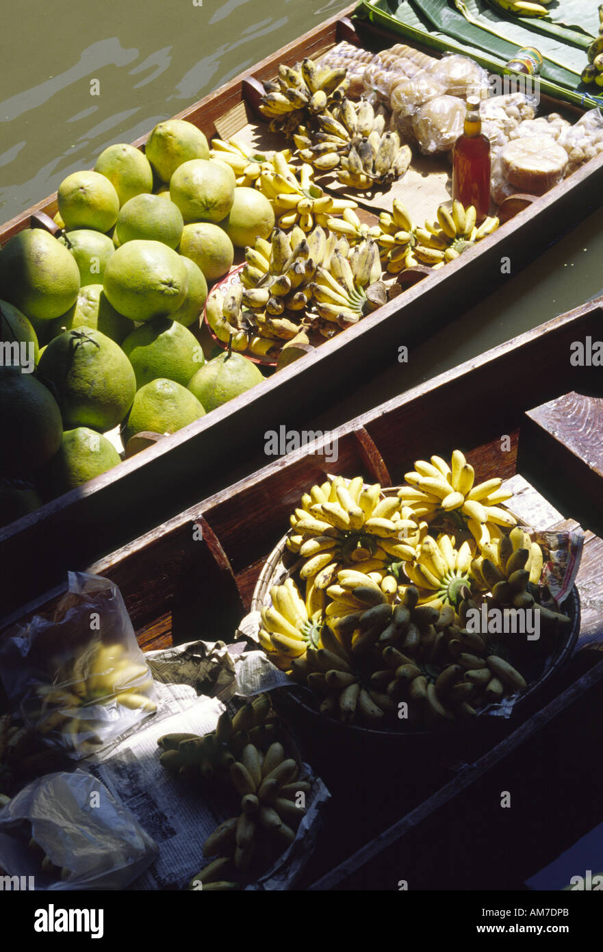 Floating market at Damneurnsaduak Thailand image of fruits displayed on 2 adjoining boats showing pomelos bananas and other loca Stock Photo
