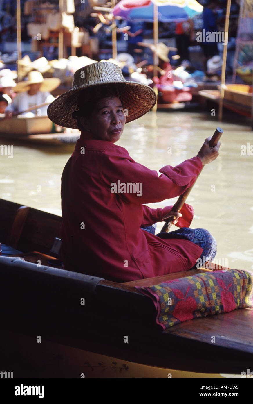 Floating market at Damneurnsaduak Thailand Image of a fruit seller on her boat paddling Stock Photo