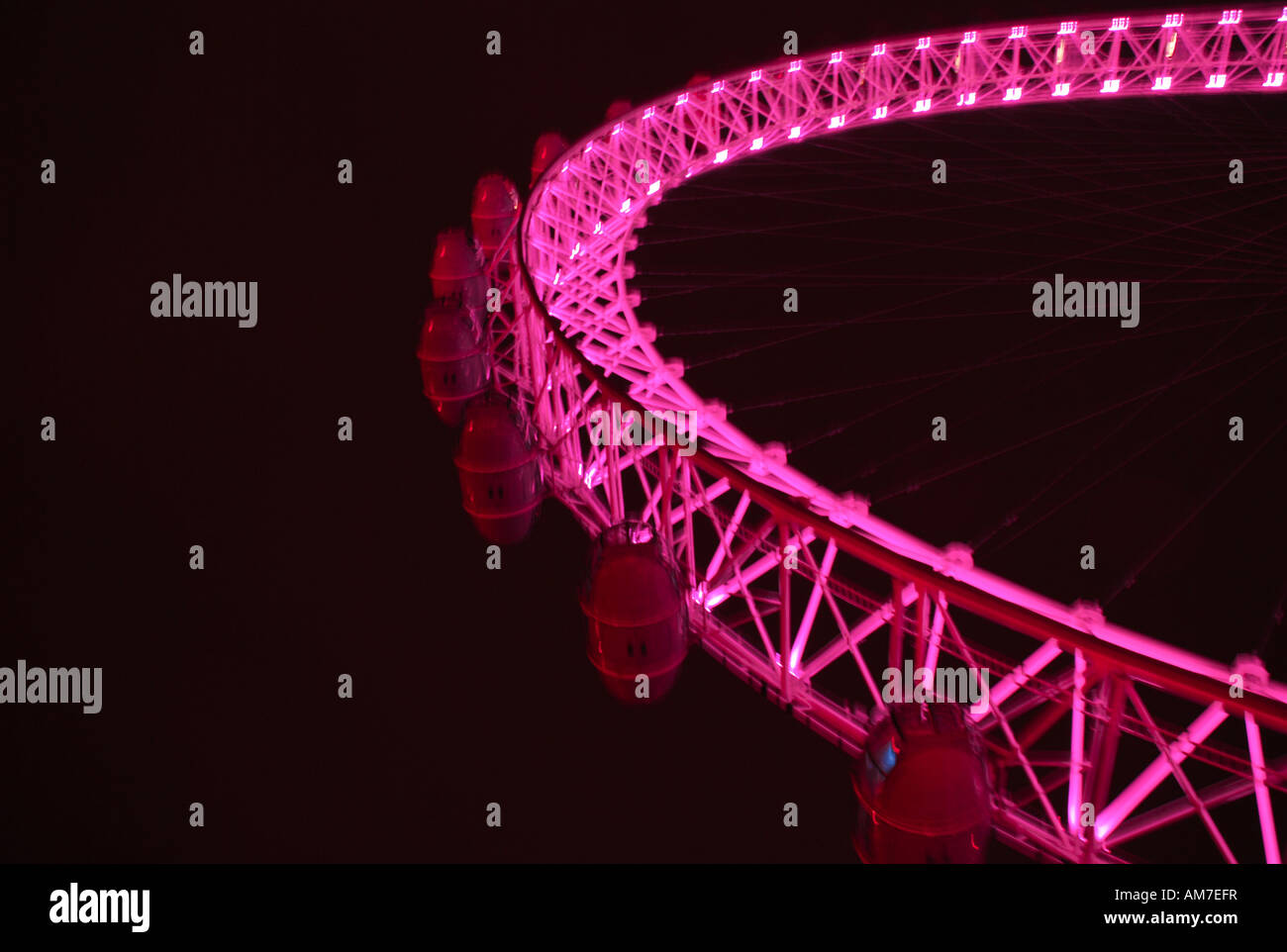 The millenium wheel at night in pink neon lights Stock Photo