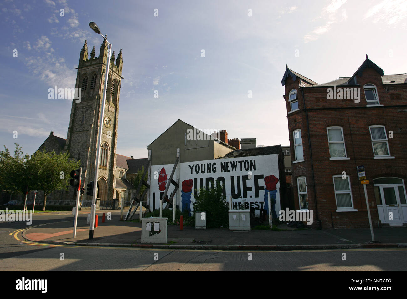 Typical West Belfast war mural for UDA UFF under the shadow of a protestant church, Newtownards road East Belfast Northern Ire Stock Photo