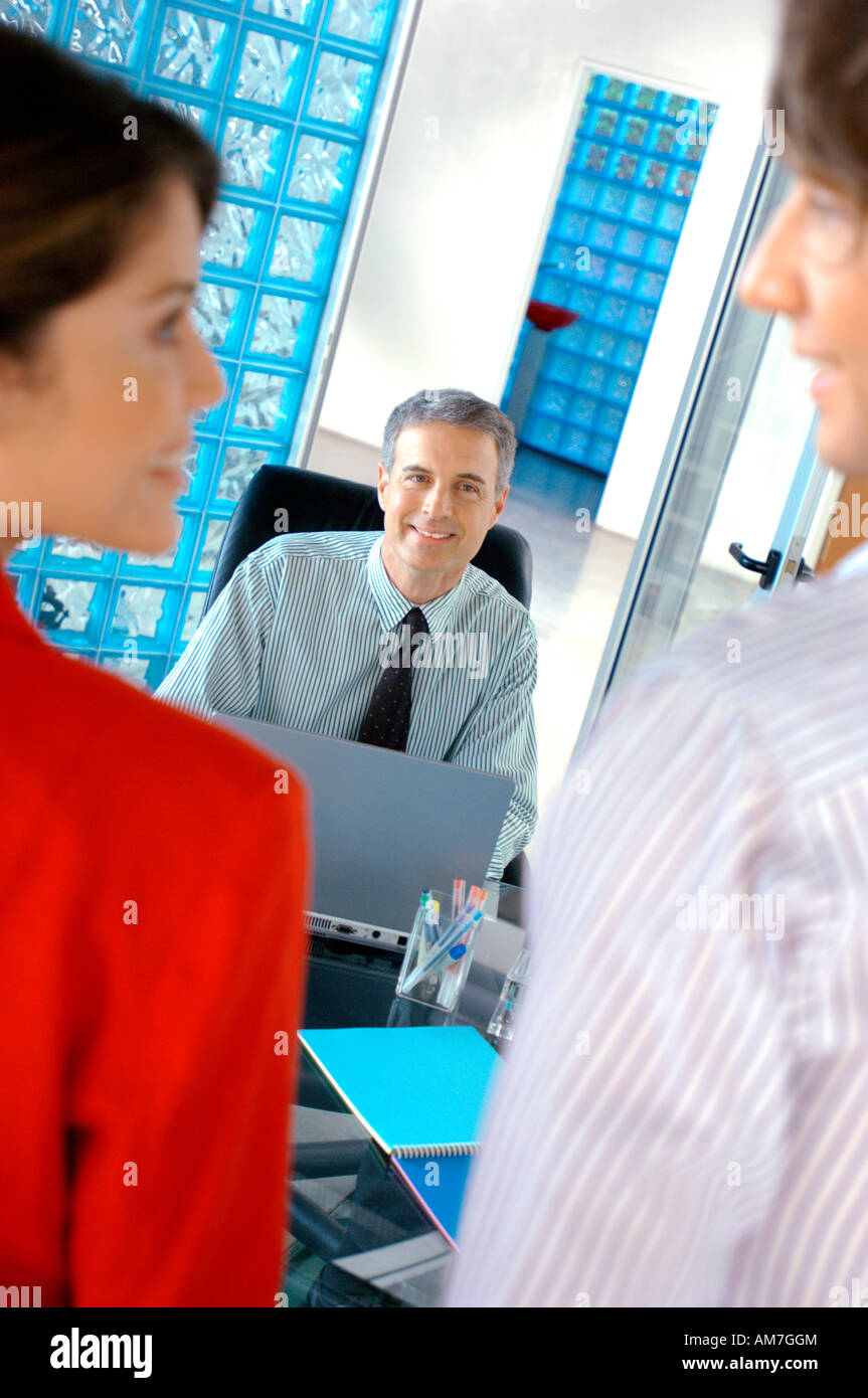 Business people smiling in office Stock Photo - Alamy