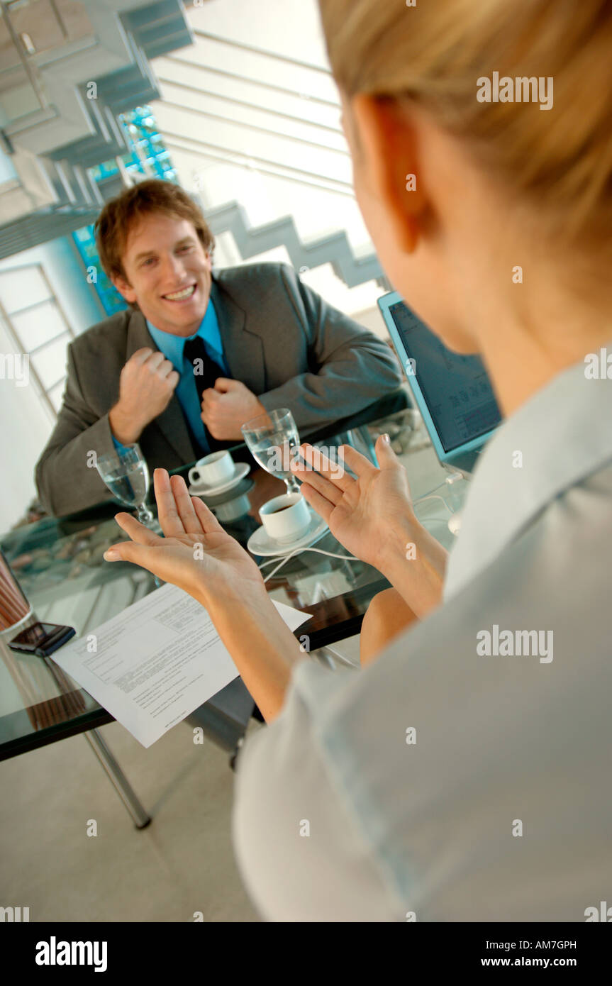 Businesswoman conversing with man in office Stock Photo