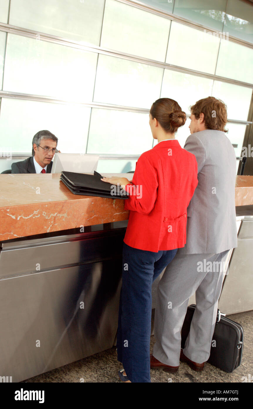 Businessmen and businesswoman standing in office Stock Photo - Alamy