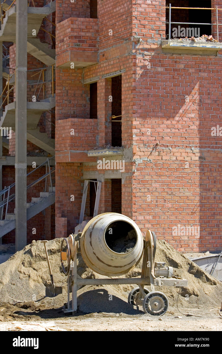 Cement mixer brick building and rubble on Spanish building site Stock
