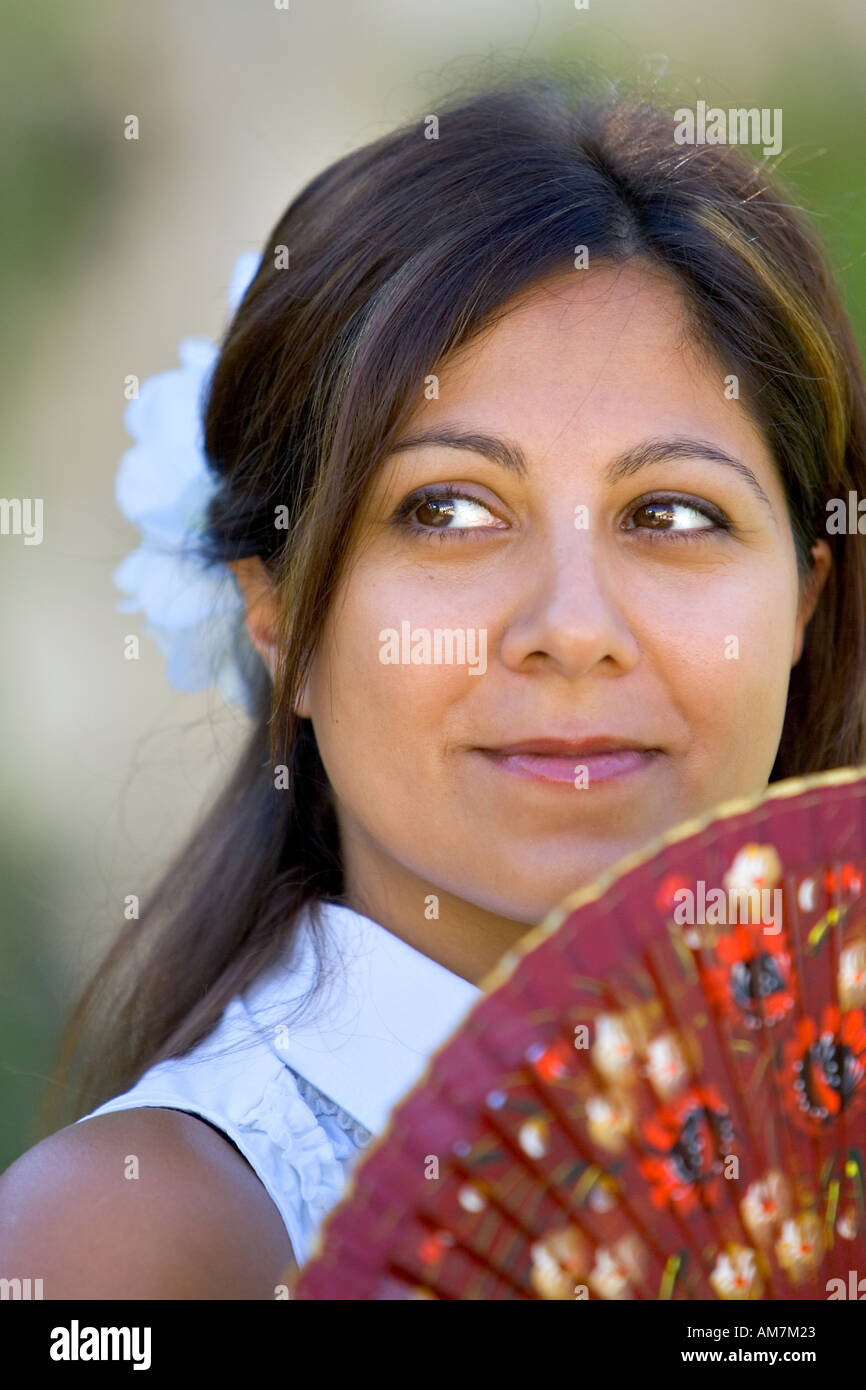 Young Spanish girl or woman smiling for camera holding traditional fan  Stock Photo - Alamy