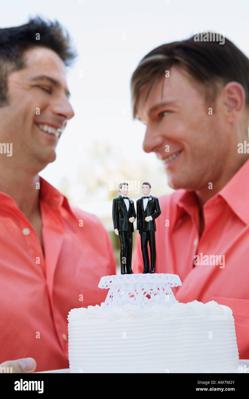 Newlywed gay couple displaying grooms on their wedding cake Stock Photo