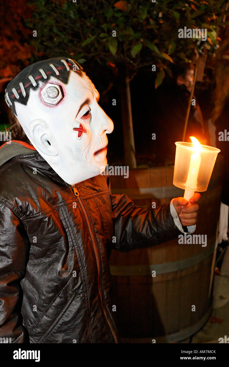 Litlle boy with Frankenstein mask holding a candle, Halloween event for children, theatre museum Duesseldorf, NRW, Germany Stock Photo