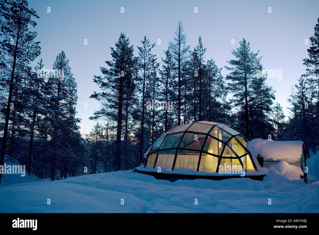 Finland glass igloo at the Kakstauttanen Igloo Village in Finnish Lapland just before sunrise during the artic winter Stock Photo