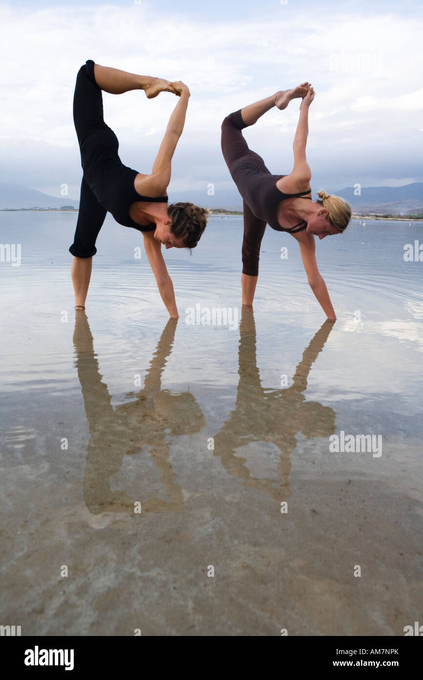 two woman practice yoga balance pose in nature Stock Photo