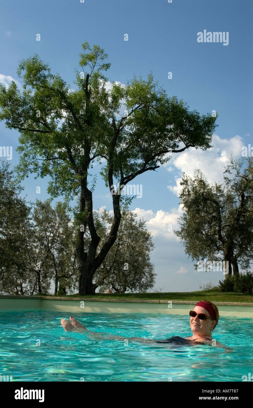 Tuscany Italy Italian woman swimming pool holiday Stock Photo
