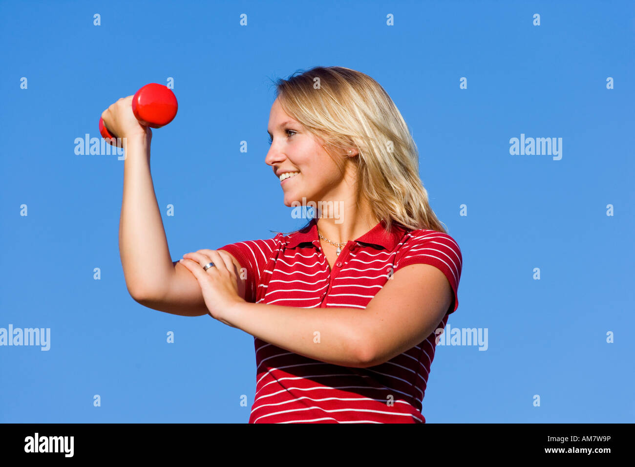 A young woman, 20 years old, training with barbells Stock Photo