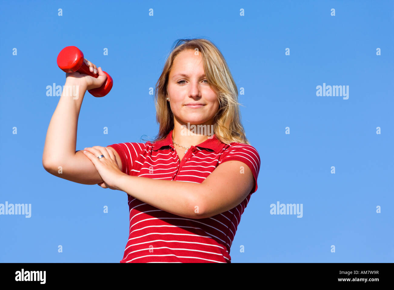 A young woman, 20 years old, training with barbells Stock Photo
