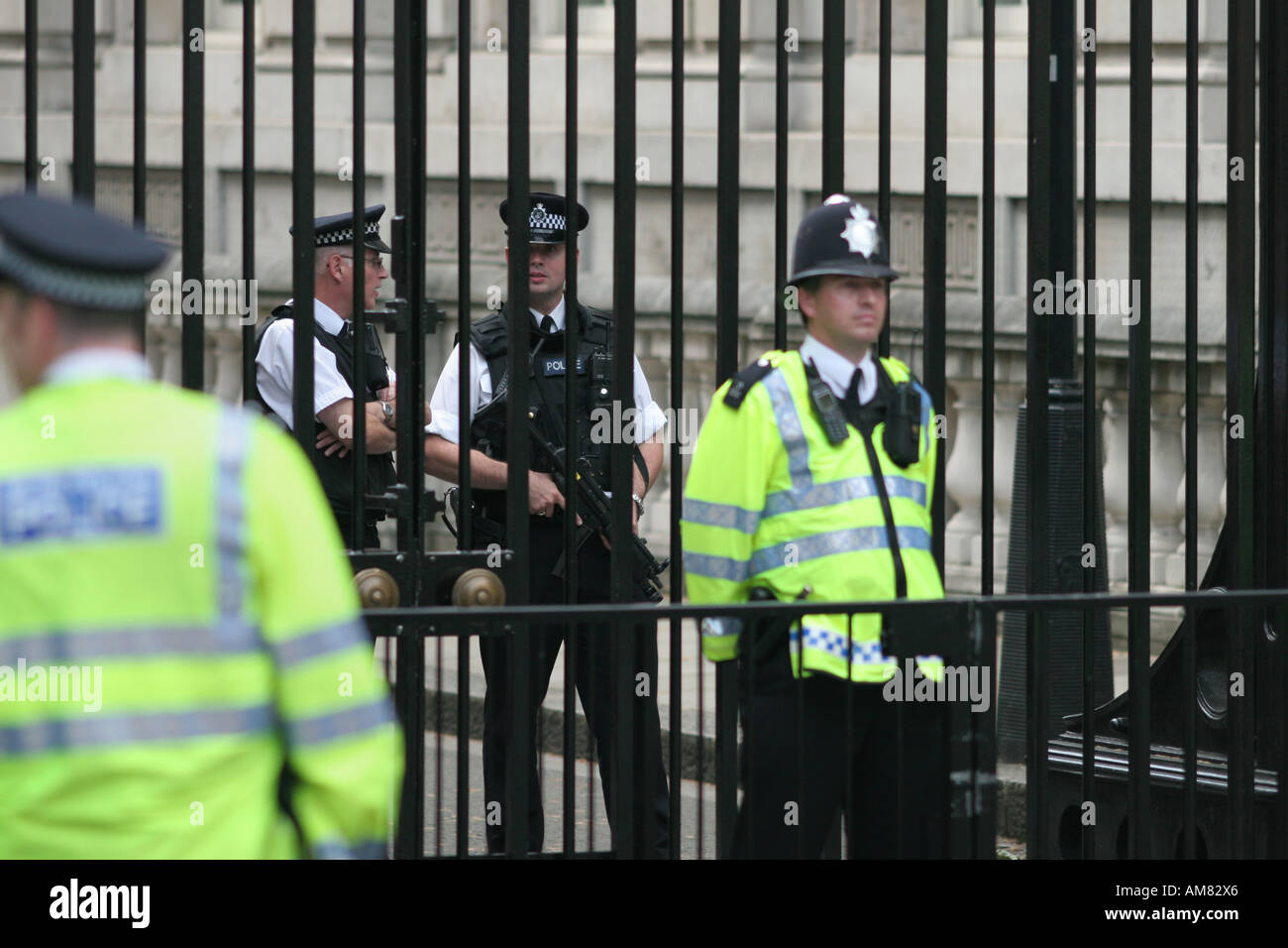 Police officers guarding the gates at Downing Street in London UK Stock Photo