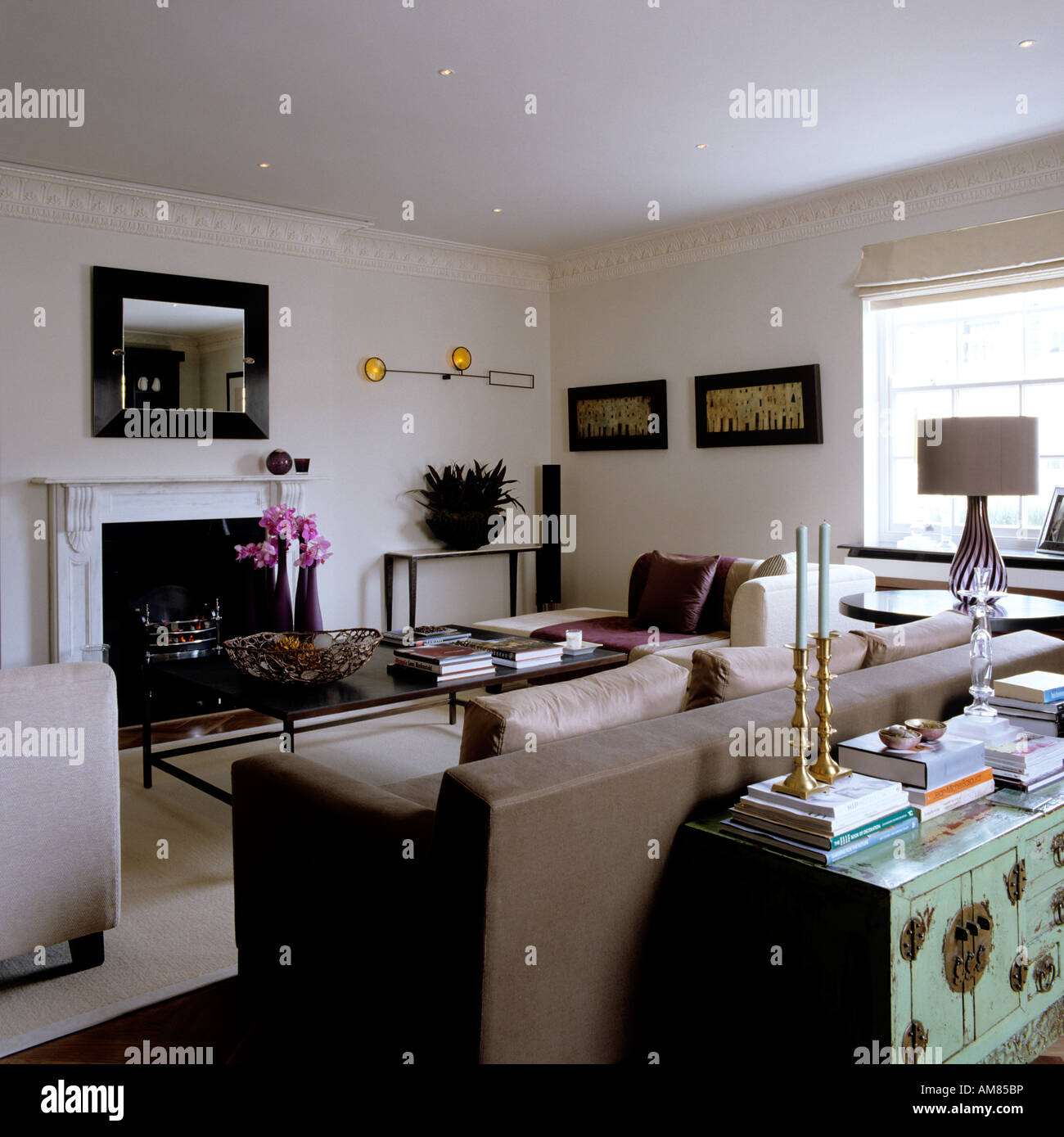 Modern sitting room with fireplace and coffee table in luxury London