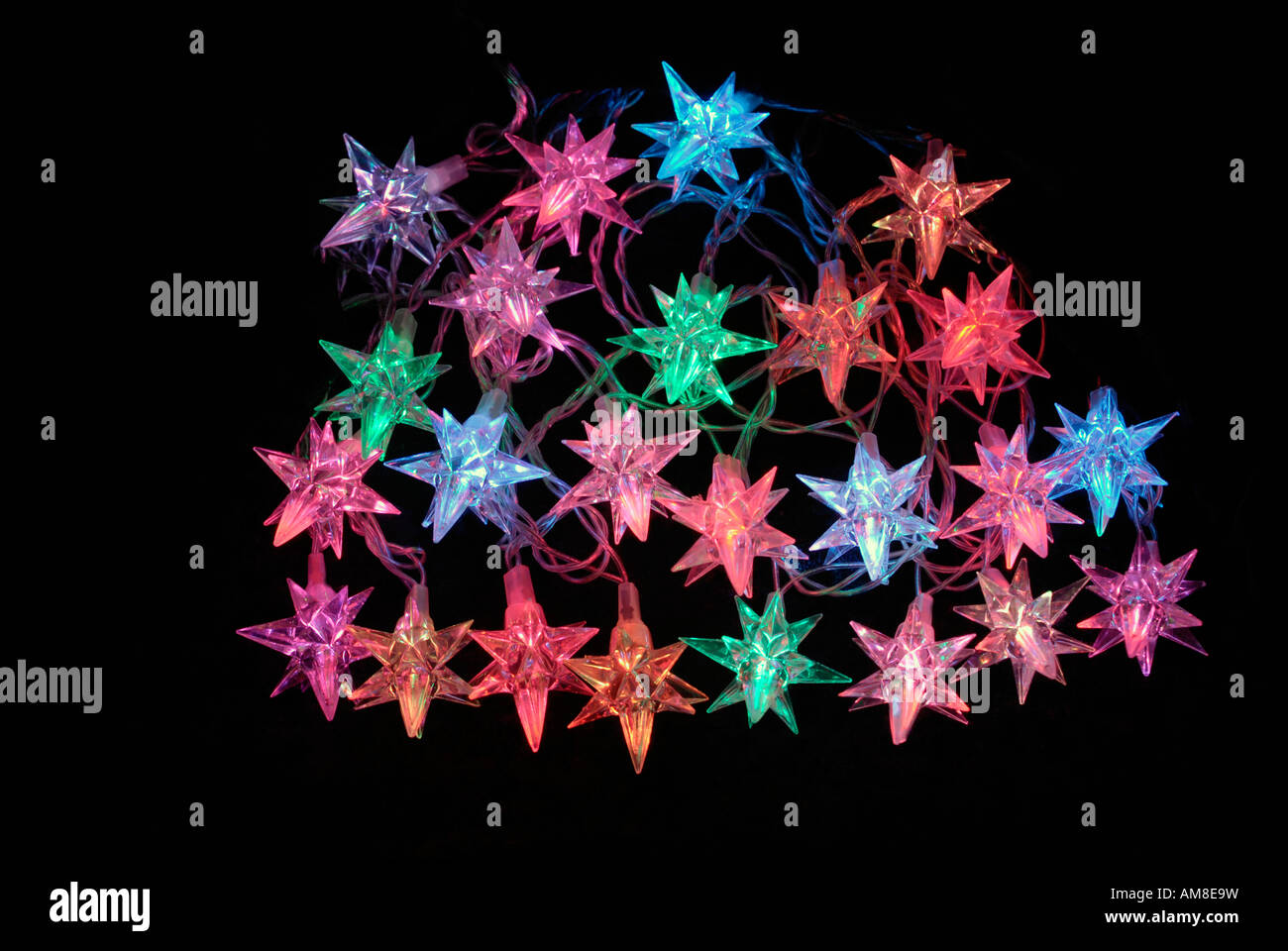 A portrait of some star shaped christmas fairy lights seen here shining