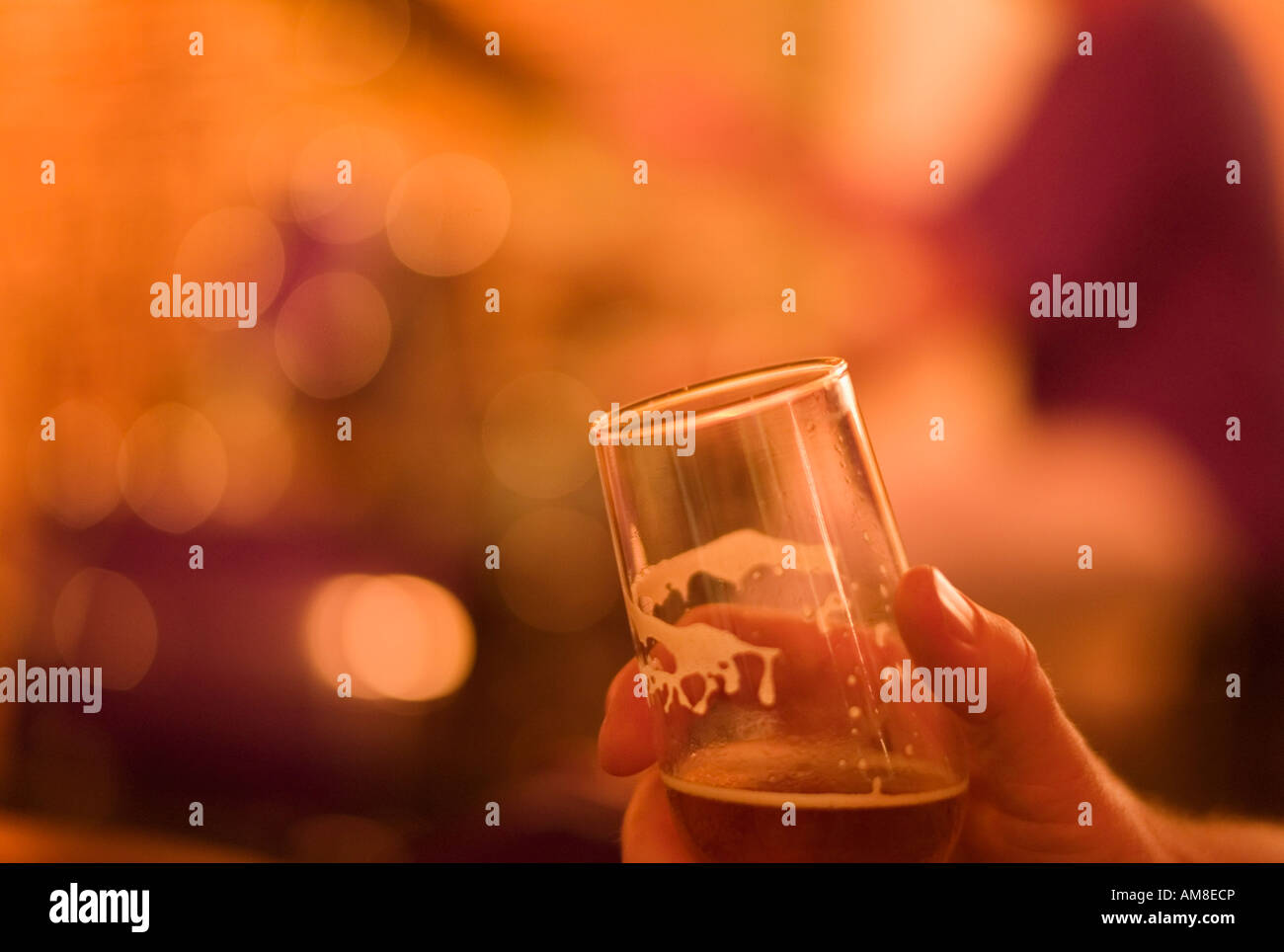 Man at bar holding glass of beer Stock Photo - Alamy