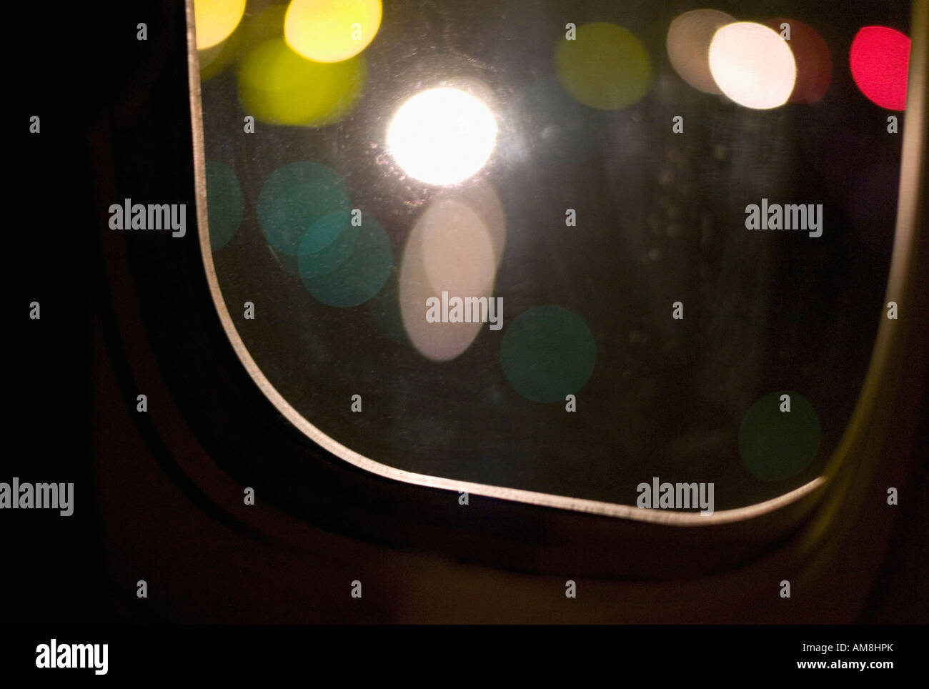 Interior of passenger jet airplane window at nigh taxing down the runway in New York's JFK John F Kennnedy Airport. Stock Photo