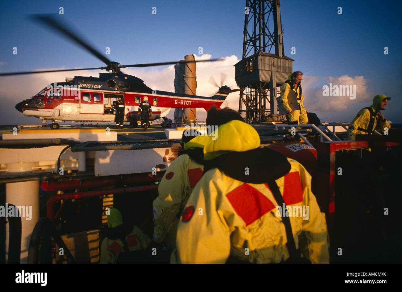 Offshore Personnel disembarking from Helicopter on to North Sea Oil Platform Stock Photo