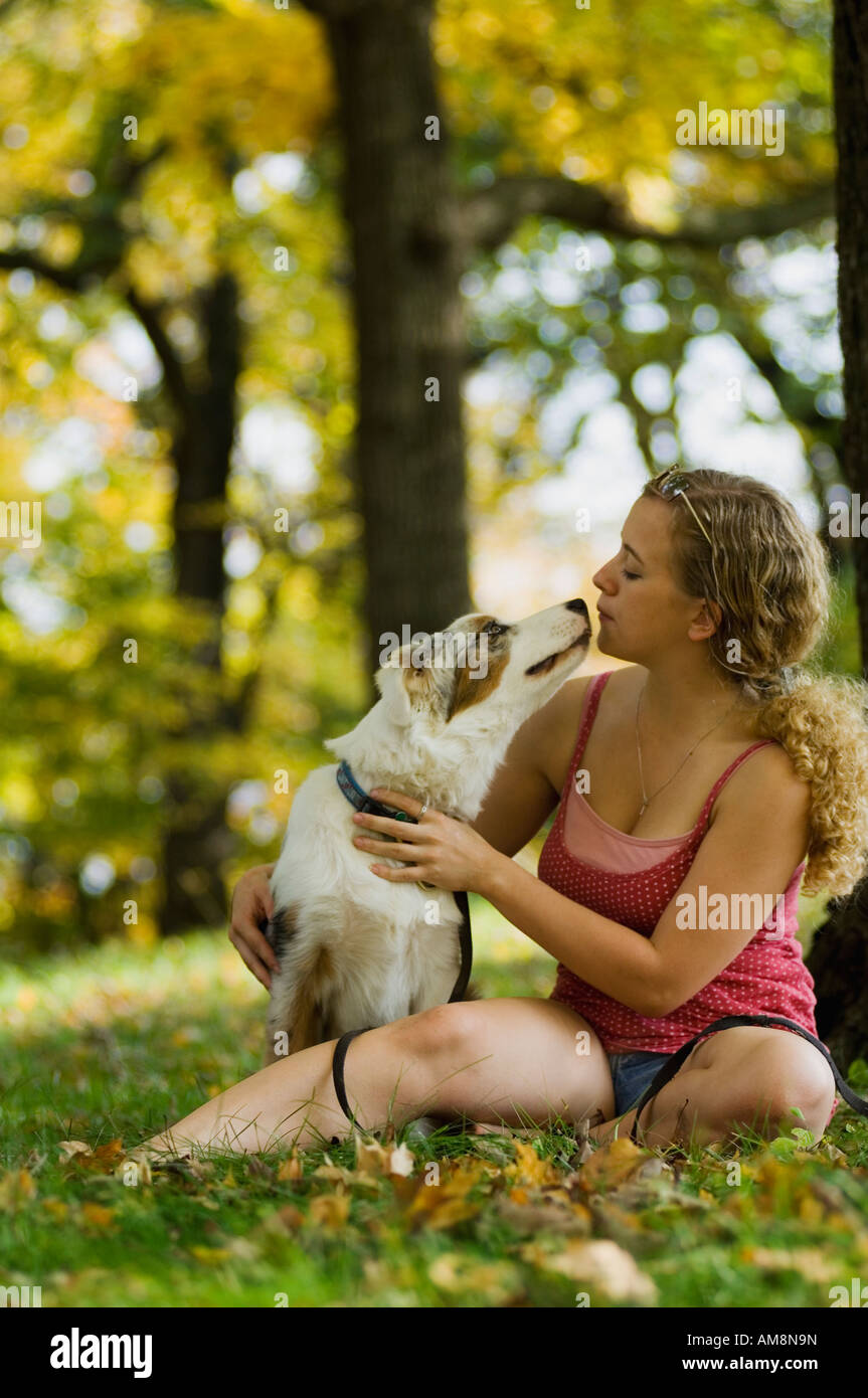 A young girl playing with her dog in the park Stock Photo - Alamy