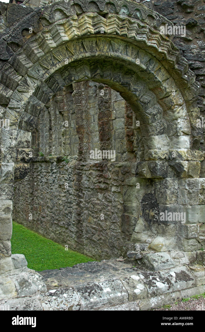 Norman romanesque round arch with decorated zig zag motif at Wenlock Priory Much Wenlock Shropshire Stock Photo