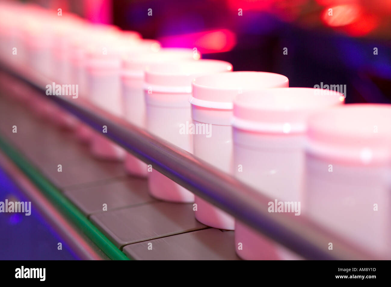 Pill bottles on production line at pharmaceutical factory Stock Photo