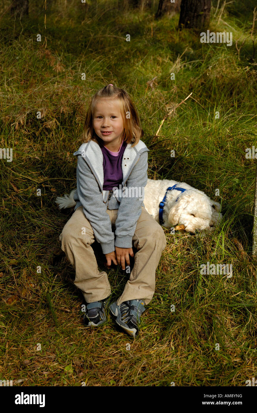 Young girl with pet dog outdoors. Stock Photo