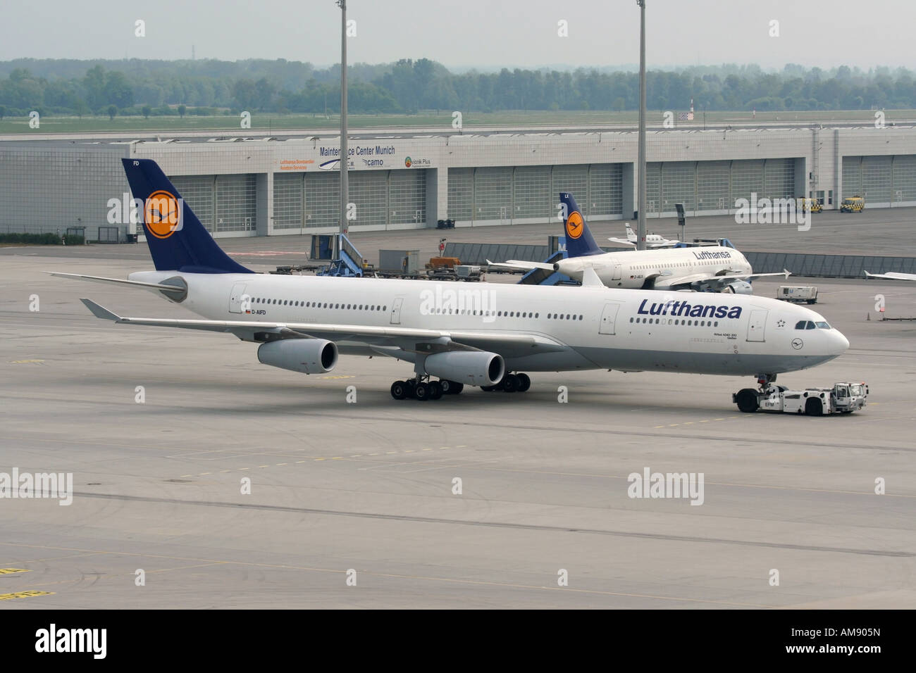 Lufthansa Airbus A340-300 passenger jet airplane under tow at Munich Airport Stock Photo