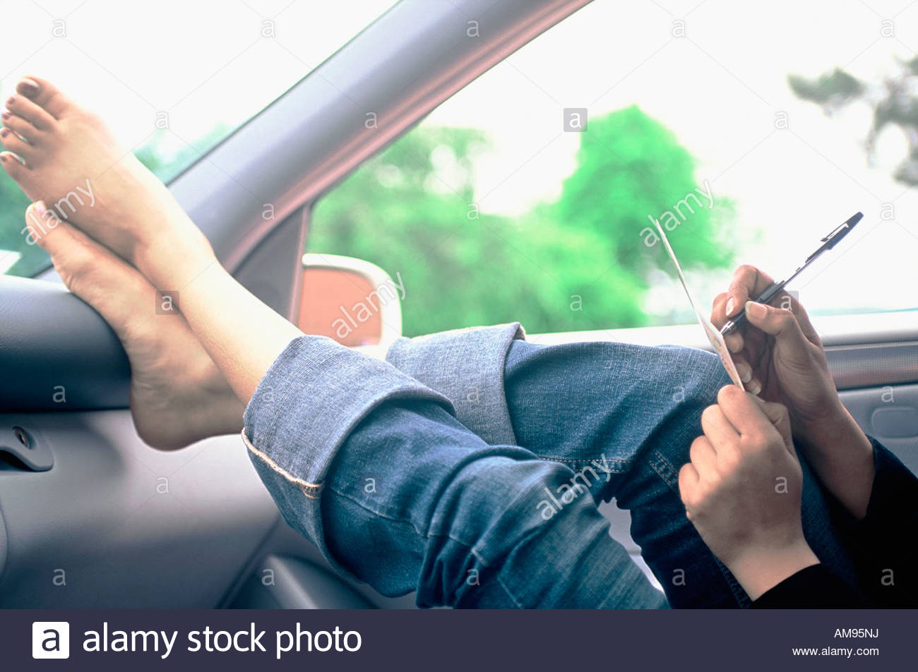 Woman resting feet on dashboard Stock Photo 15189581 Alamy
