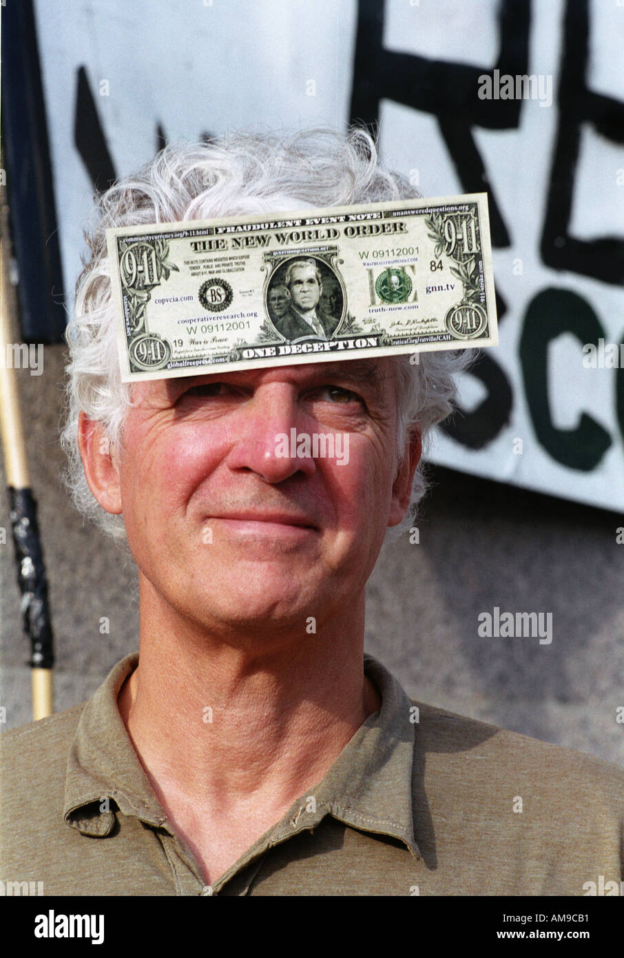 Man with us dollar bill on forehead protesting Iraq war Stock Photo