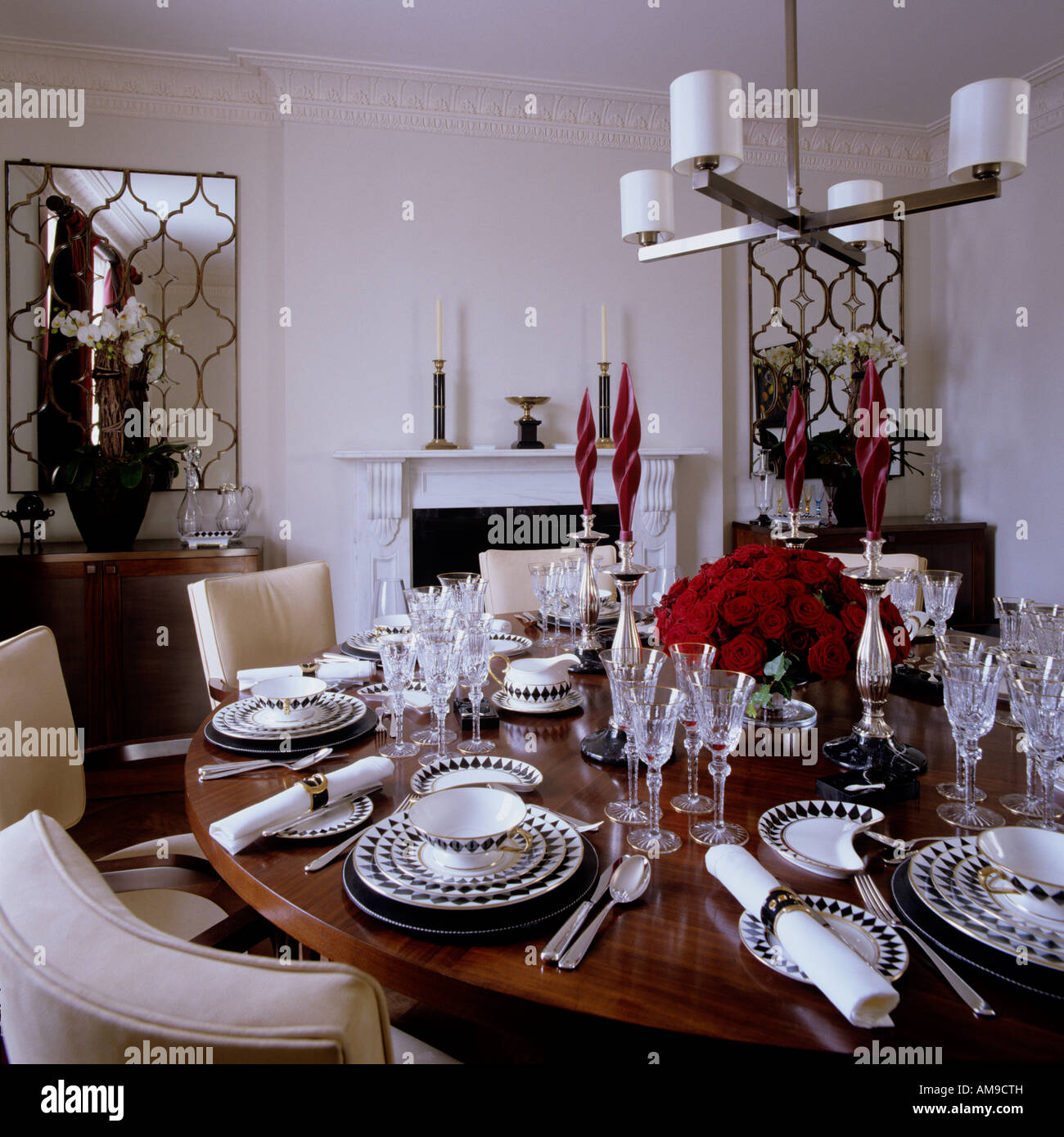 Wenge table formally laid with cutlery and crockery in luxury modern