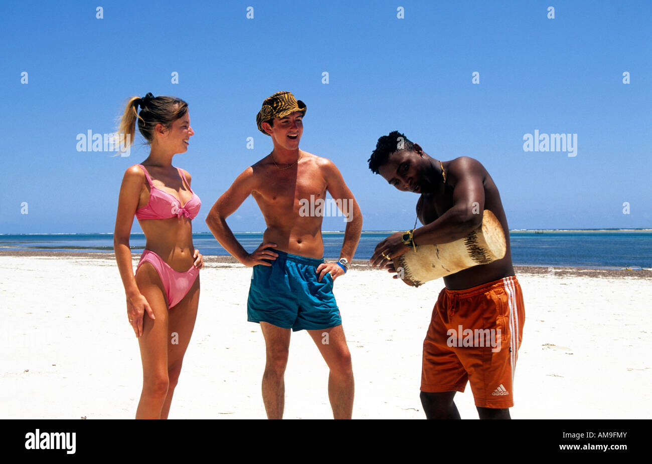 east africa kenya mombasa north shore beach a couple with a vendor selling  drums Stock Photo - Alamy