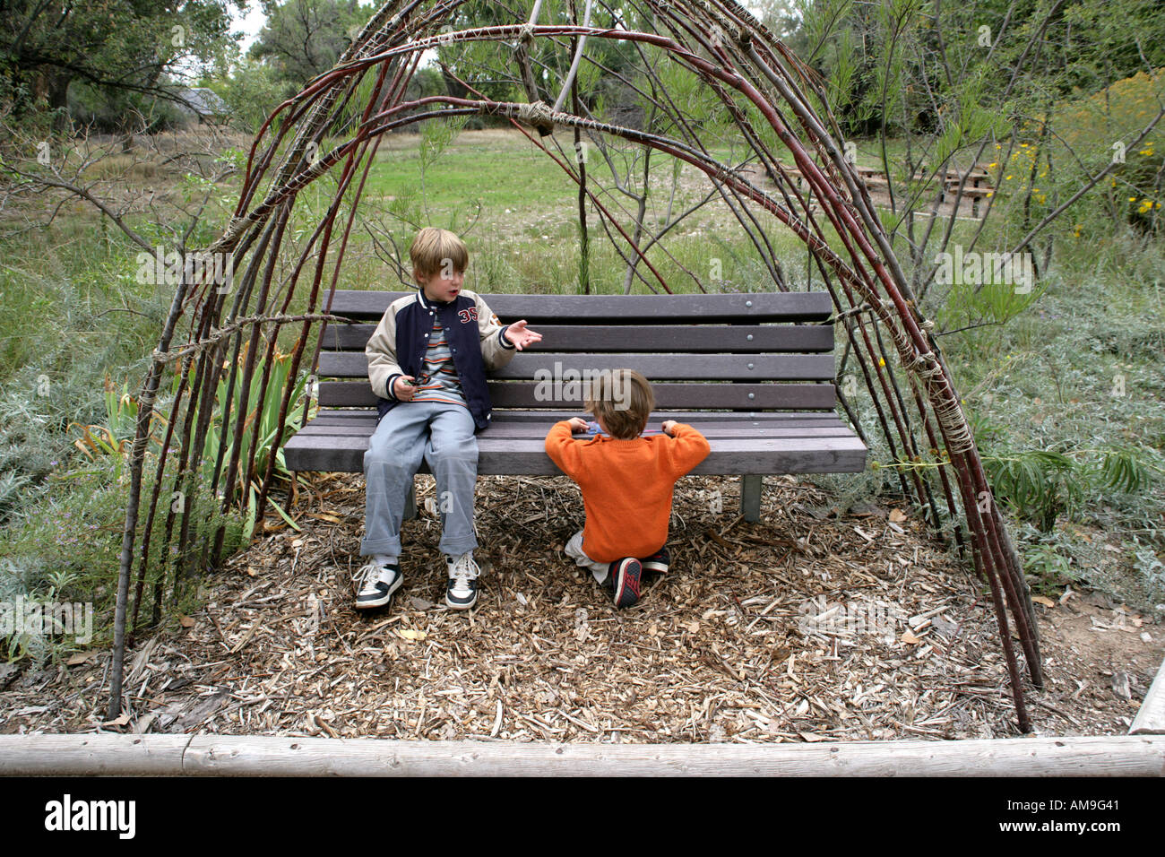 brothers conversing outdoors Stock Photo